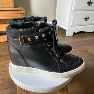 Aldo black wedge sneaker with gold accents.